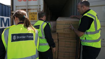 UK Border Force official inspecting a shipping container