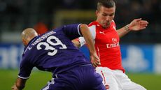 Anthony Vanden Borre of Anderlecht battles with Lukas Podolski of Arsenal