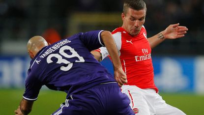 Anthony Vanden Borre of Anderlecht battles with Lukas Podolski of Arsenal