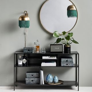 fringed wall lamp with mirror grey wall