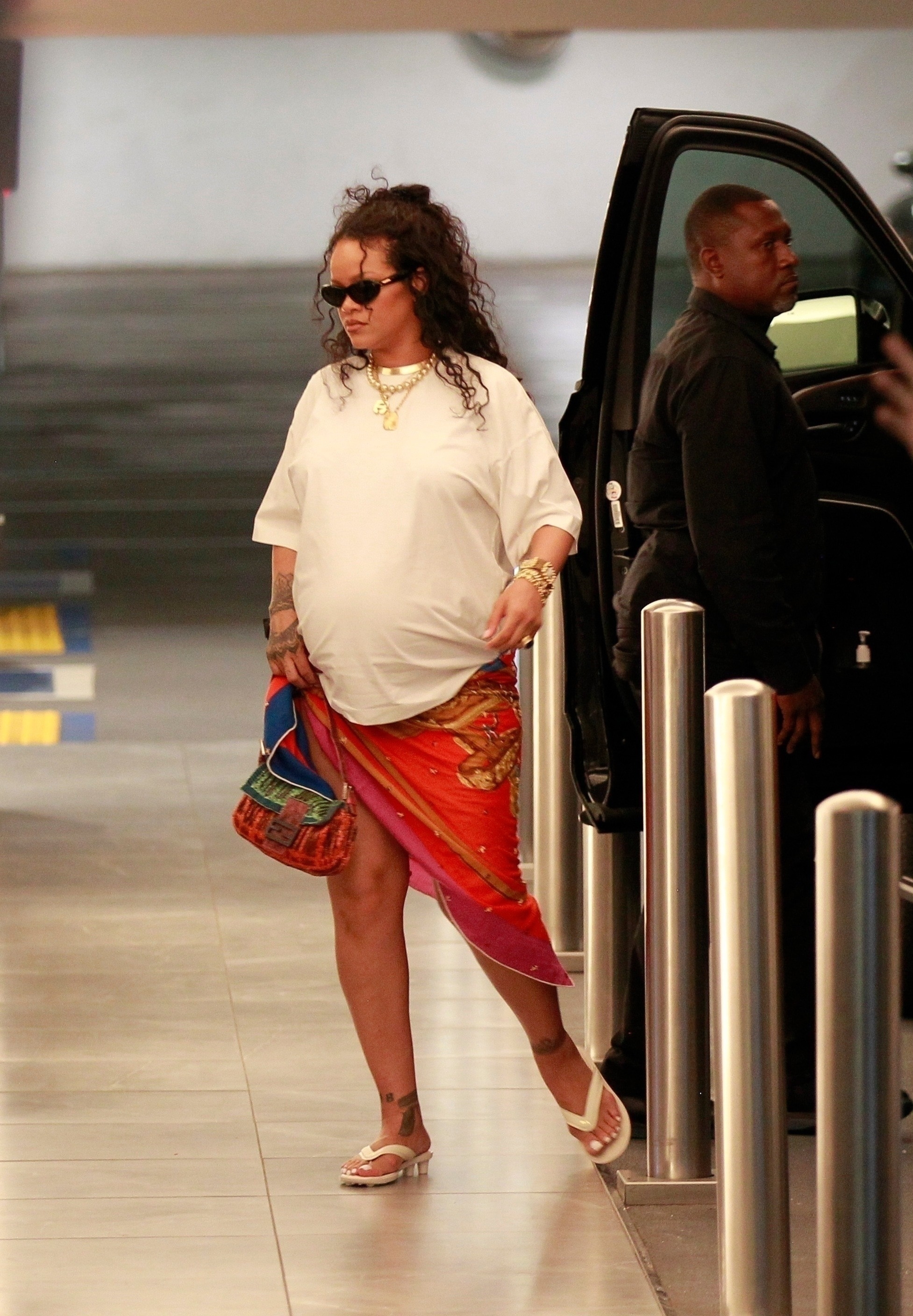 Rihanna paired a white T-shirt with Puma x Fenty flip-flops and a rare Fendi Baguette