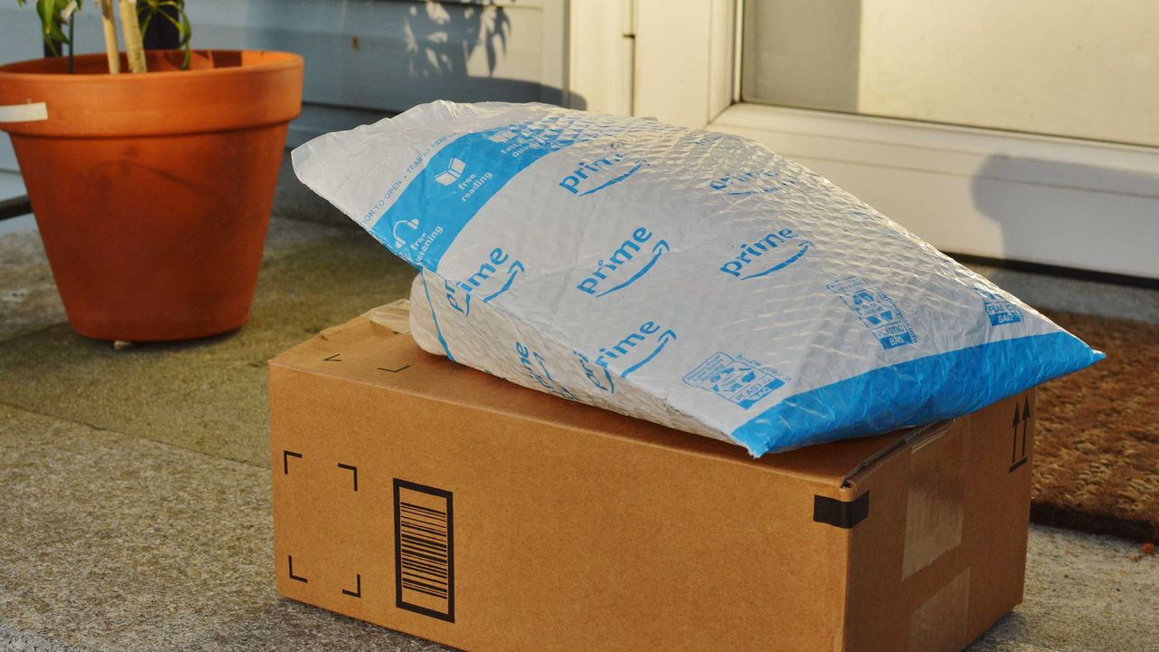  An Amazon Prime delivery driver wearing personal protective equipment delivers packages during the shelter in place order and quarantine.