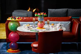 Table laid for Bulgari afternoon tea, with cake stands and napkins