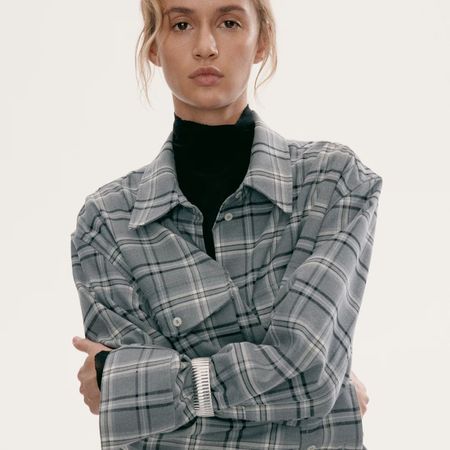 Model wearing grey checked shirt