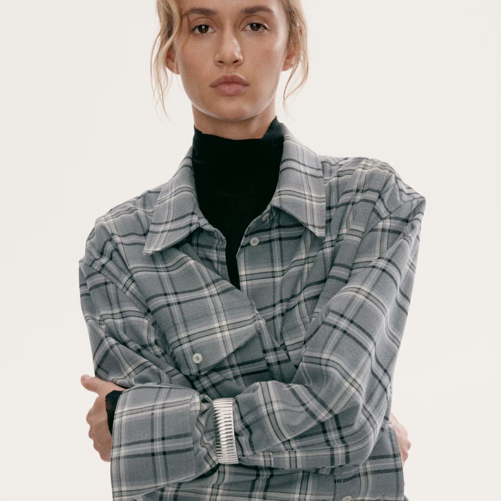 Model wearing grey checked shirt