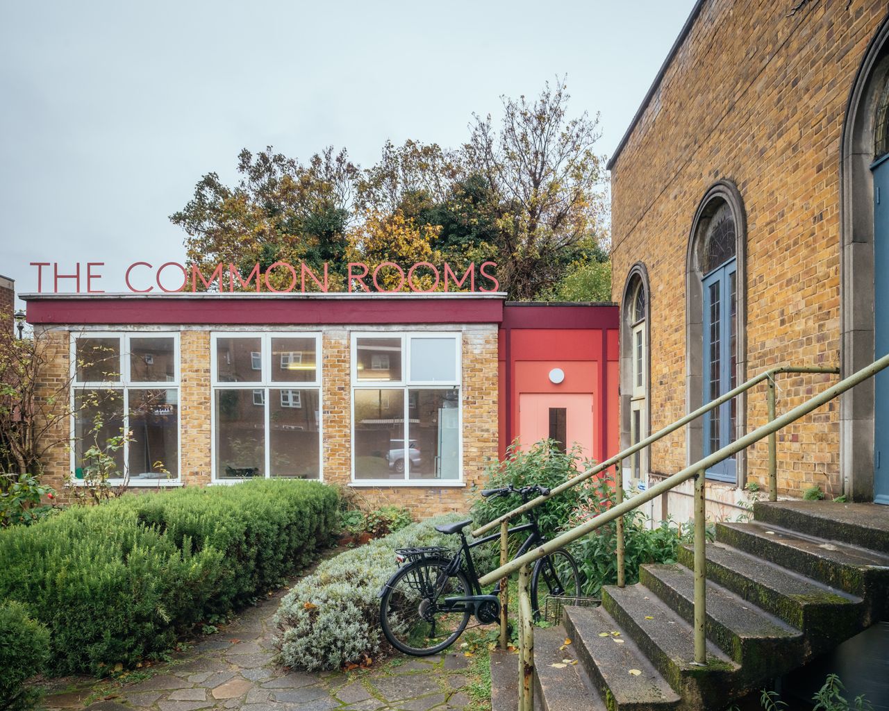 The Common Rooms exterior with steps and signage