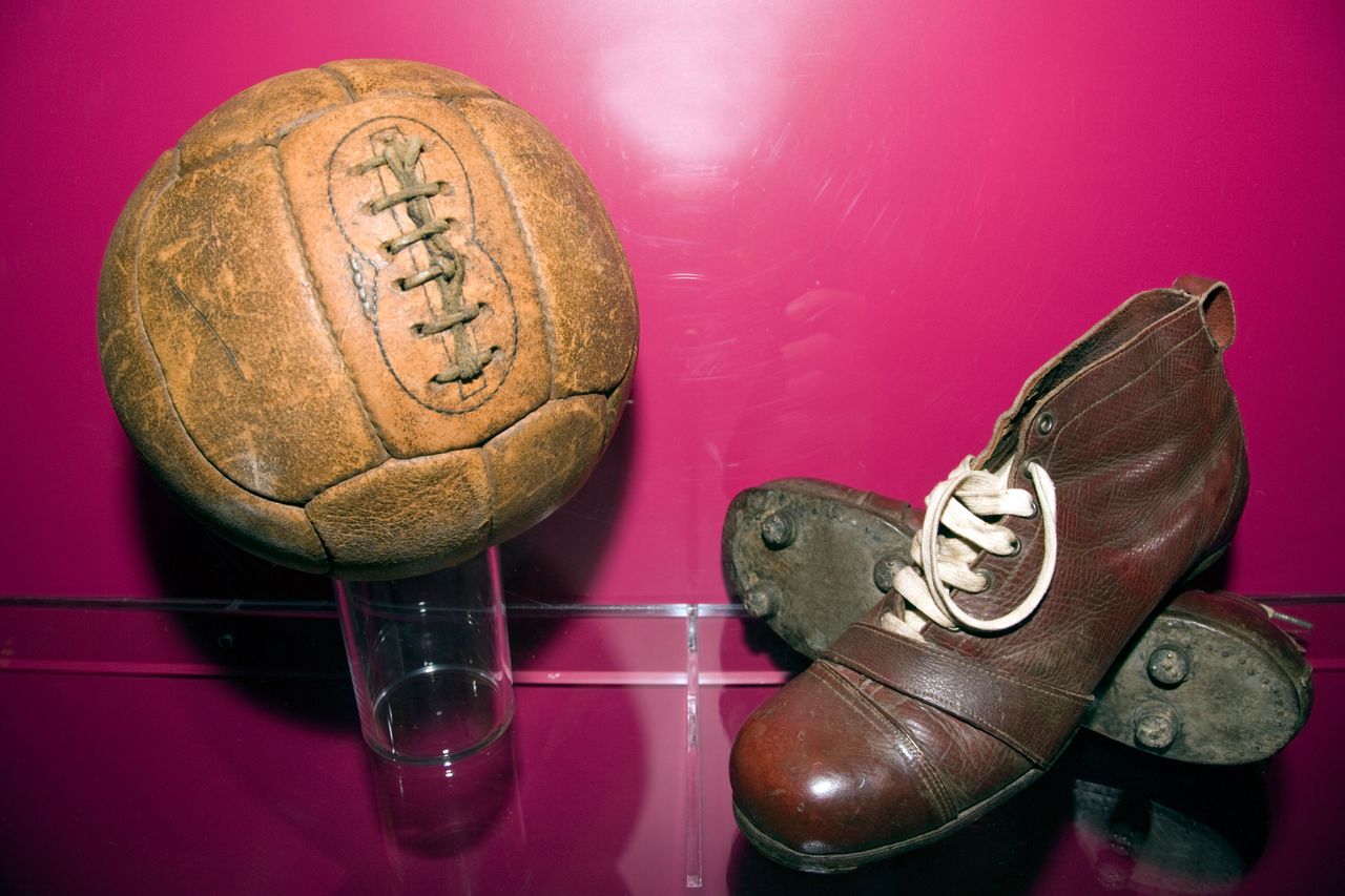 An old football and pair of football boots at the Camp Nou in Barcelona, Spain