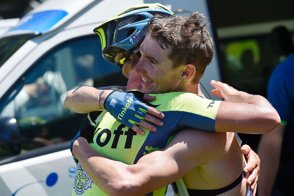 A teammate congratulates Jay McCarthy after his stage 2 win.