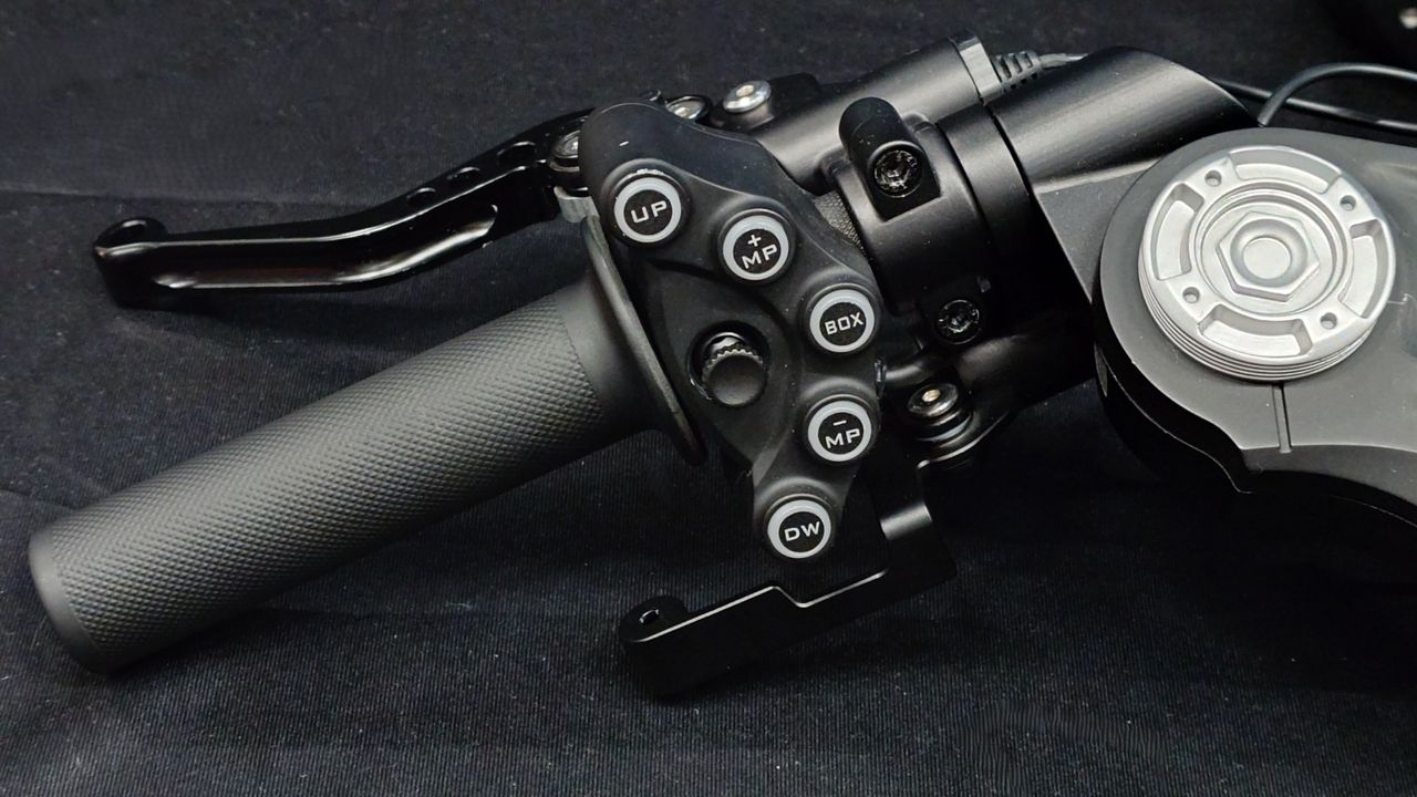 Close up photos of the Moza Racing MotoGP handlebars on a black backdrop.