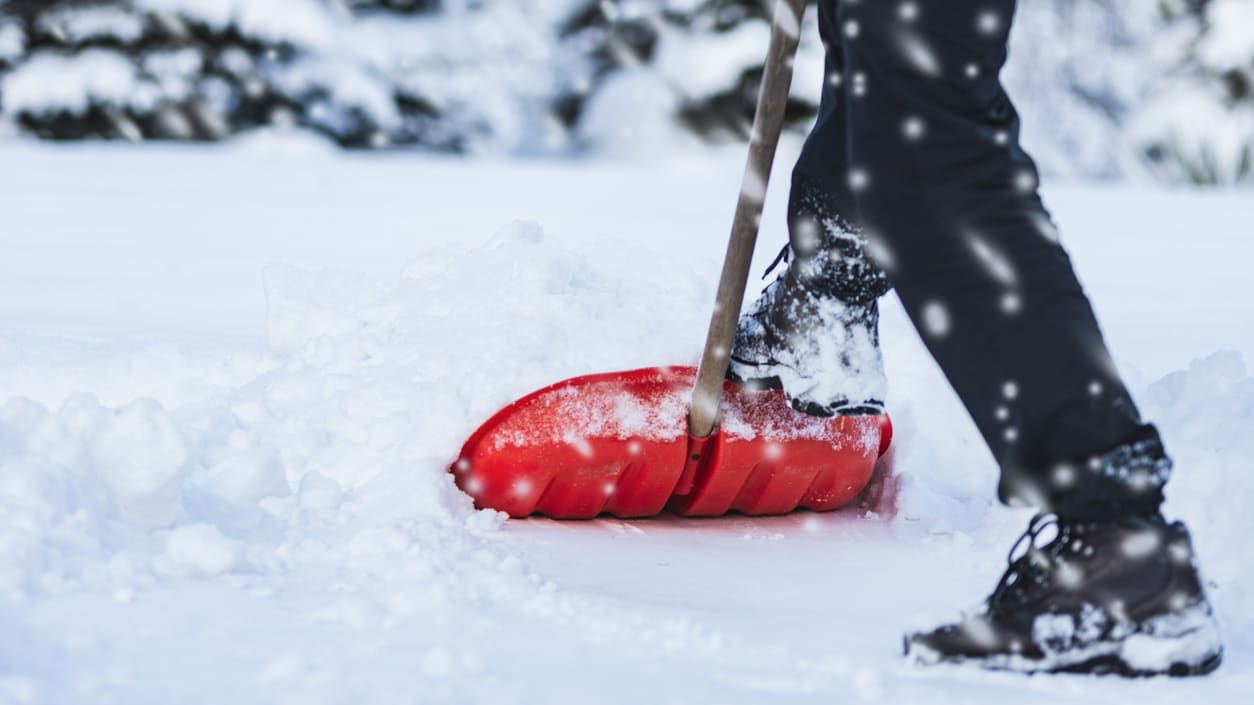 A man shovels snow.