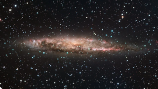 The galaxy NGC 4945 as seen by the European Southern Observatory’s 2.2-meter telescope with sites of star formation visible in pink and its central AGN obscured by dust