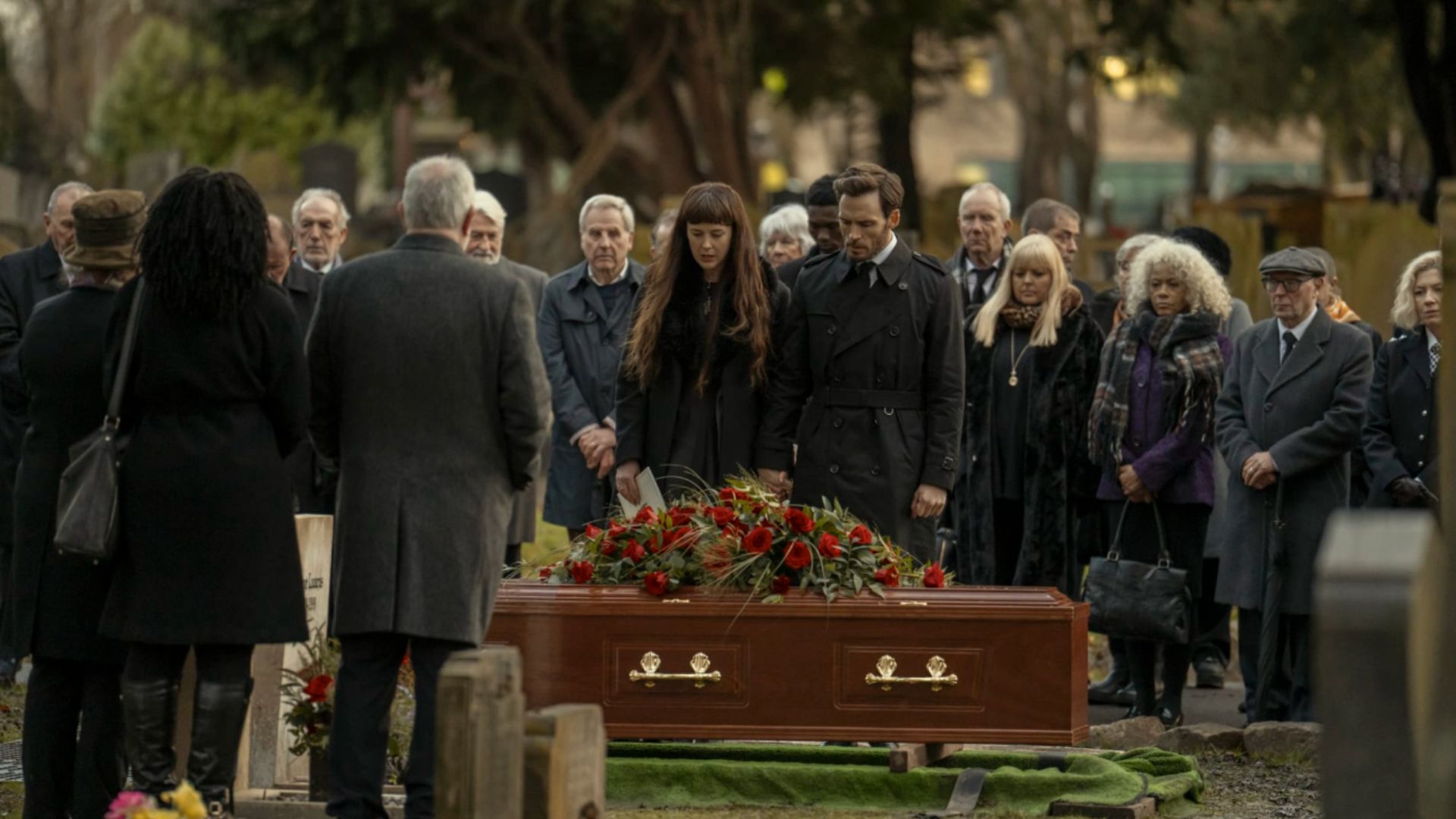 an image of sam claflin and alexandra roach in character at the funeral of their on-screen father