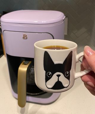 Bailey Cain testing the Beautiful by Drew Barrymore coffee maker with novelty dog mug