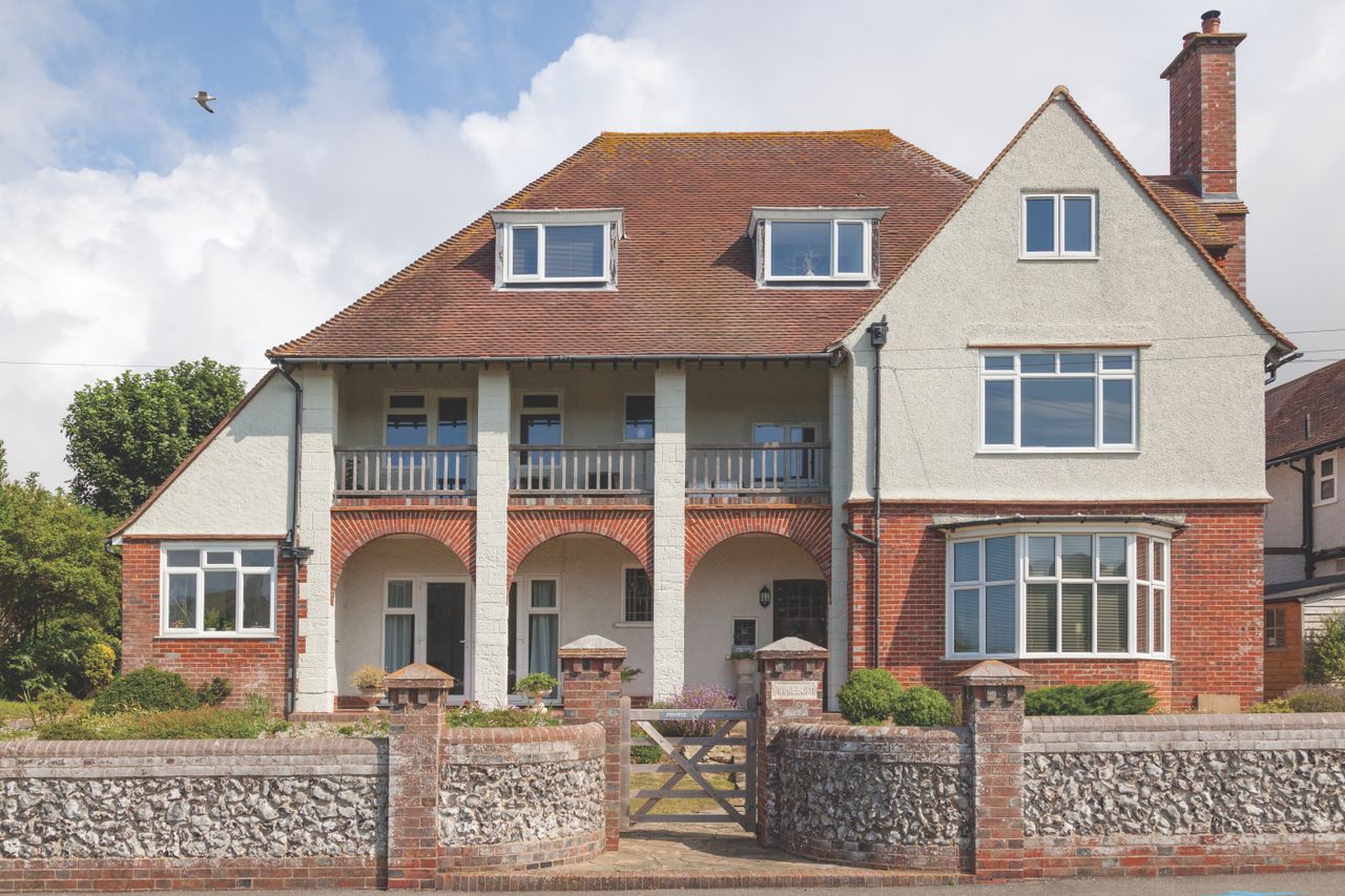 arts and crafts style house with brick and pebbledash