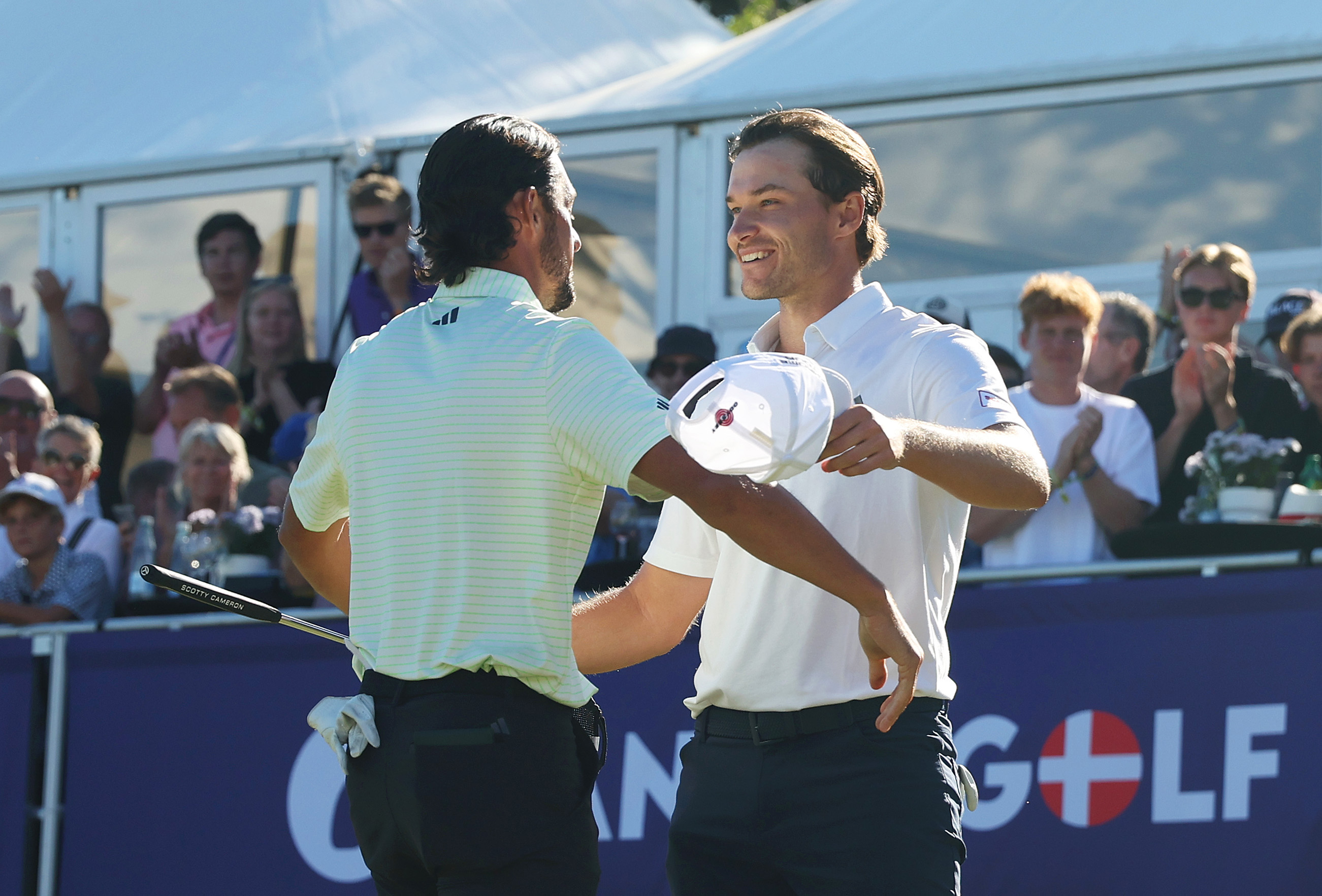Marco Penge (left) and Rasmus Hojgaard embrace after Penge won the 2025 Danish Golf Championship