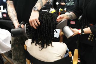 NEW YORK, NEW YORK - FEBRUARY 13: Hairstylist prepare model's hair backstage at the Romeo Hunte fashion show during New York Fashion Week on February 13, 2024 in New York City. (Photo by Udo Salters/Getty Images)