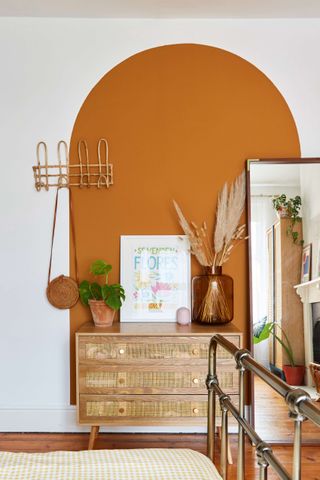 Boho bedroom with orange feature wall