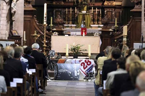 The urn was set before the altar with the sporting tributes