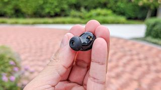 Anker Soundcore Space A40 earbud held between reviewer's finger tips