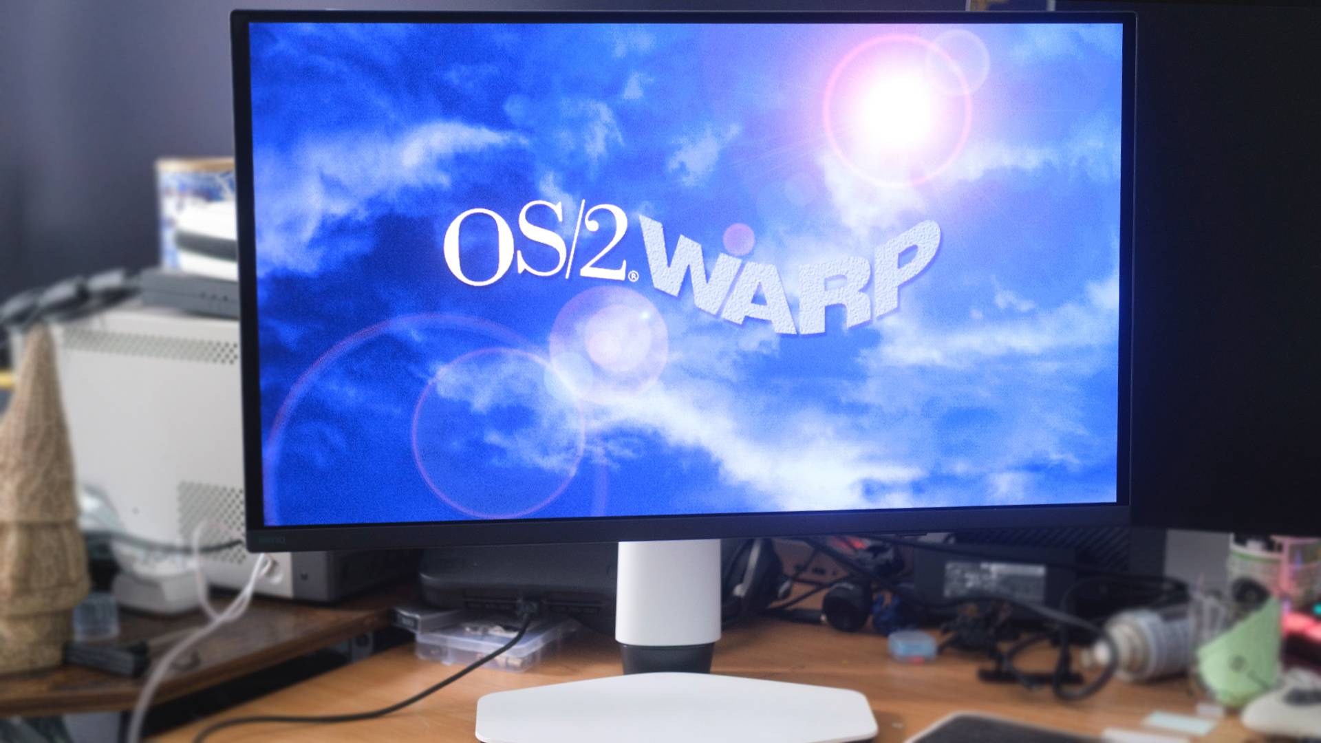 BenQ Mobiuz EX271UZ monitor with OS/2WARP sky wallpaper on screen.