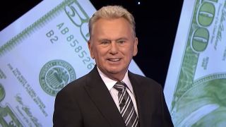 Pat Sajak smiling while joking with contestant on Wheel of Fortune