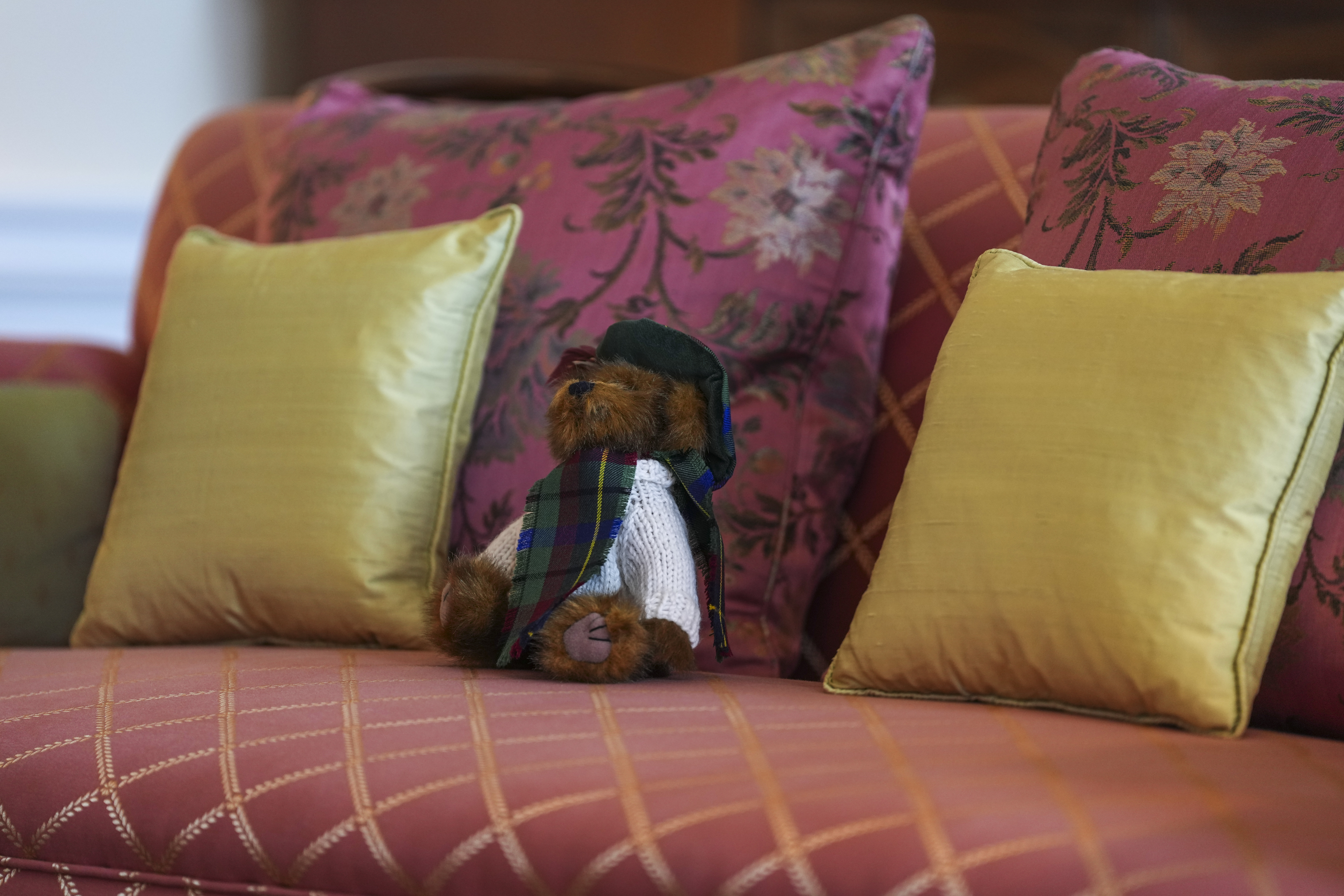 Queen Elizabeth's teddy bear sitting on a sofa