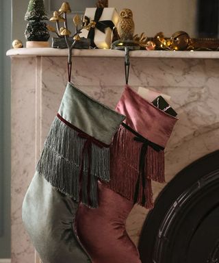 christmas stockings on marble fireplace