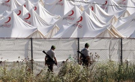 Turkish soldiers patrol the Syrian refugees camp on the Turkish-Syrian border: