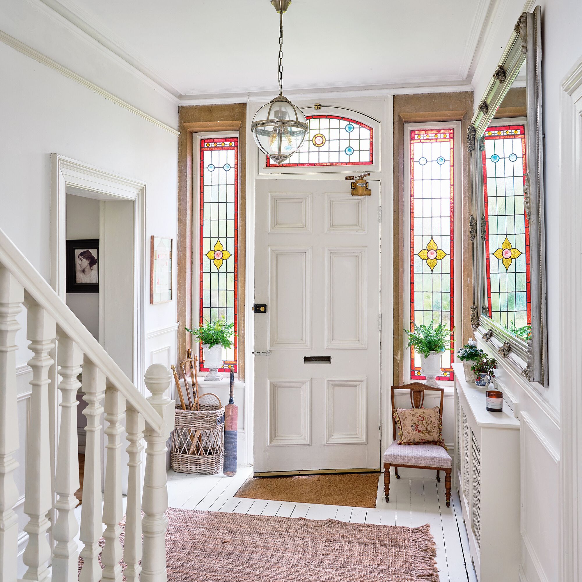 stained glass windows in hallway with white walls and door