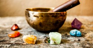 Tibetan singing bowl surrounded by crystals to show how to cleanse crystals with sound waves
