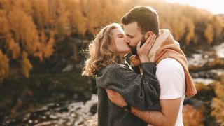 Couple kissing in forest during hike