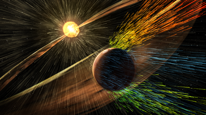 A NASA artist’s rendering of a solar storm hitting Mars and stripping ions from the planet's atmosphere