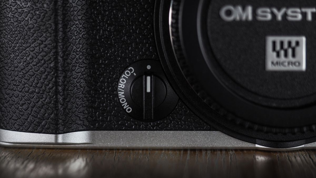 OM System OM-3 on a wooden surface