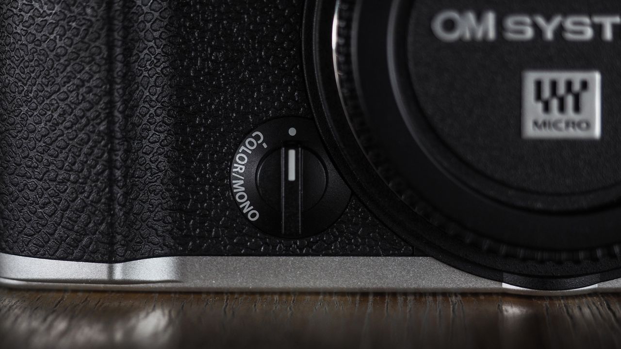OM System OM-3 on a wooden surface