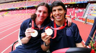 Lionel Messi and Sergio Aguero celebrate with their Olympic gold medals in 2008