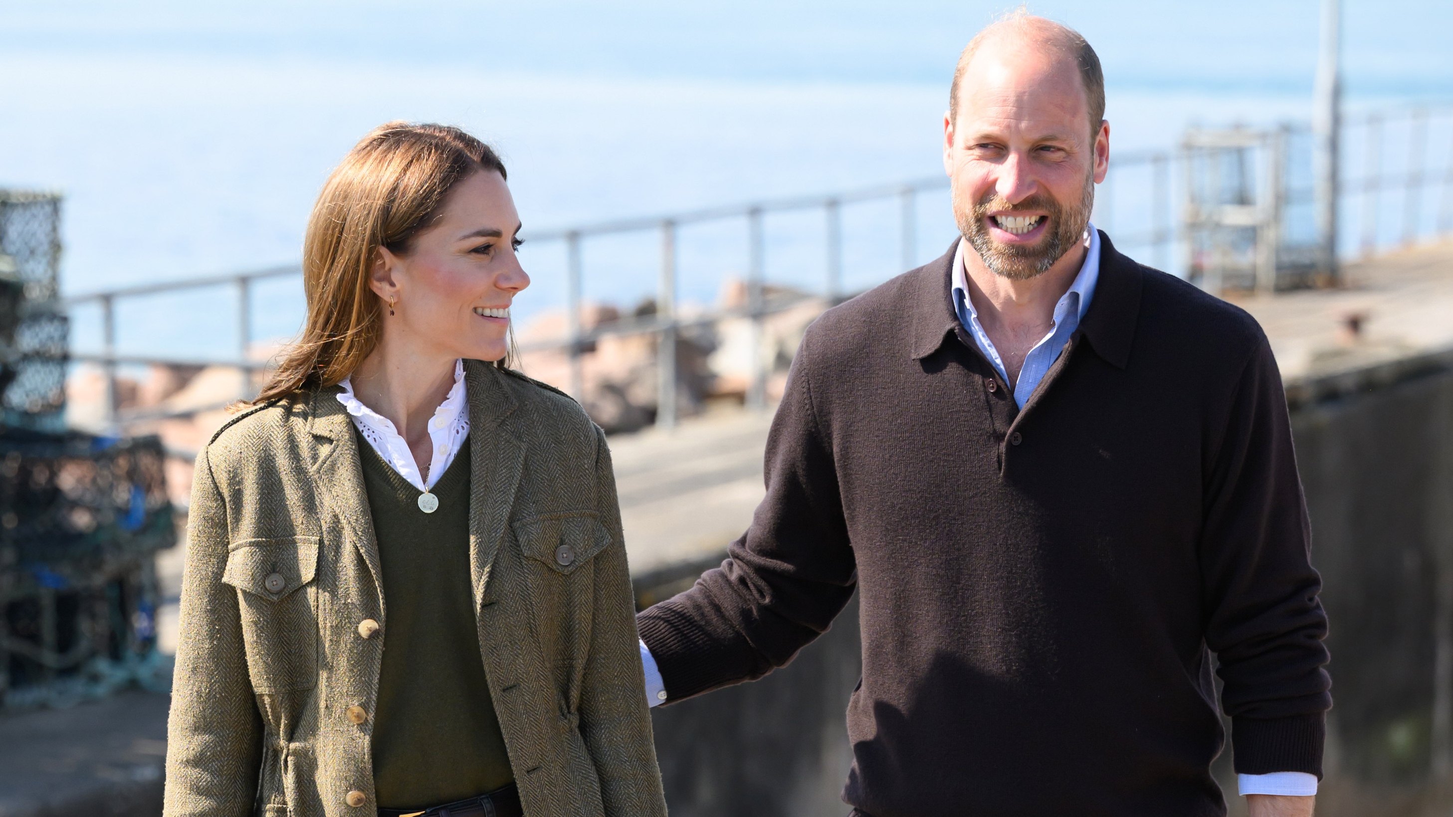Prince William puts his hand on the Princess of Wales&#039;s back as they smile and walk after returning from the island of Iona on a public ferry on April 30, 2025 in Fionnphort