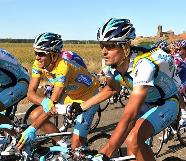 Germany's Andreas Kl&ouml;den (Astana) passes a bottle to teammate Alberto Contador, the race leader.