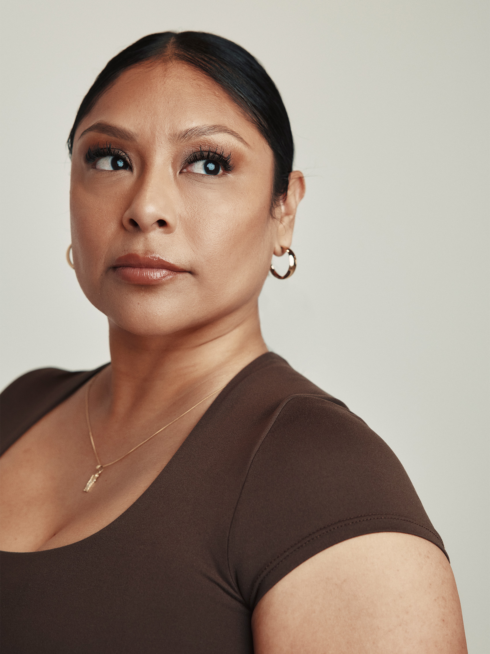 Portrait of Angelica Vargas in a brown top, looking to the side.