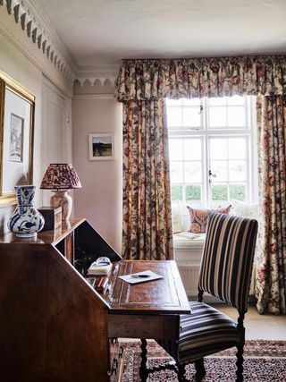 Window treatment with valance around window seat in home office