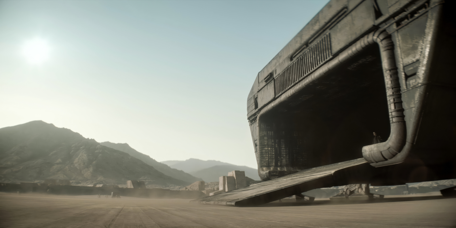 A massive spaceship lands on a barren desert planet