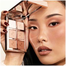 girl holding up a six pan matte eyeshadow palette