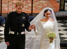 Prince Harry wears army uniform to marry Meghan Markle, who is wearing a long sleeved white gown and floor length veil