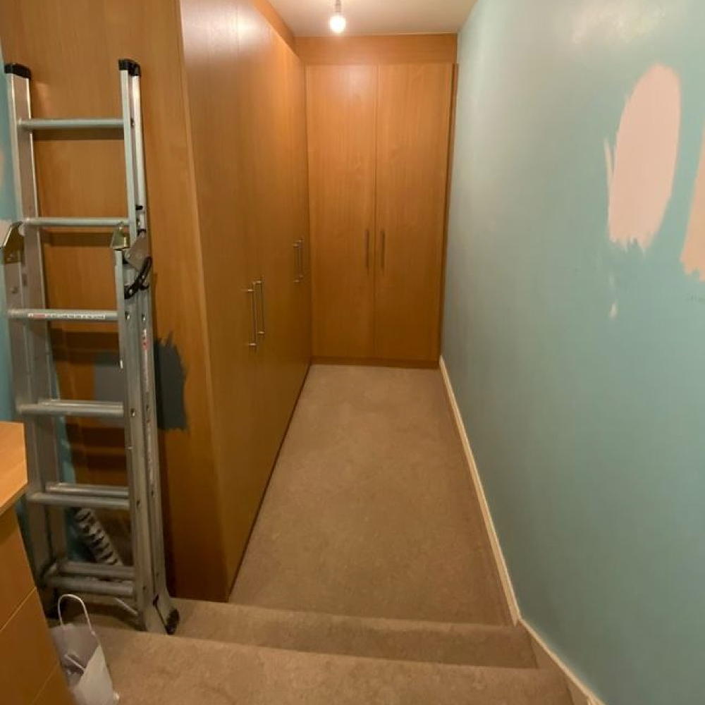 dressing room with blue wall wardrobe and ladder