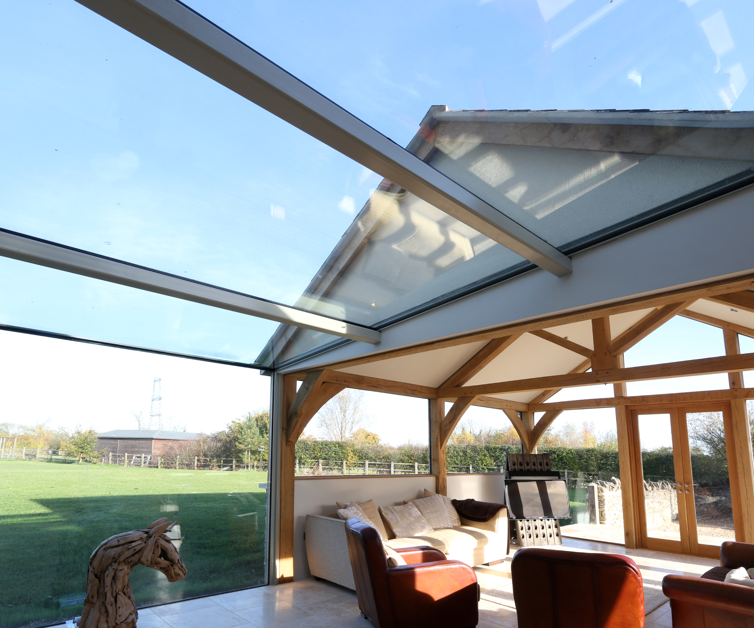 looking up at glass roof of glass linking extension