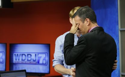 WDBJ-TV7 anchor Chris Hurst comforts meteorologist Leo Hirsbrunner.