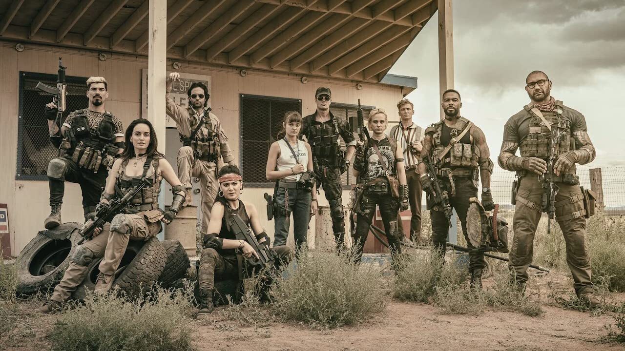 The Army of the Dead cast lined up in front of a shack.