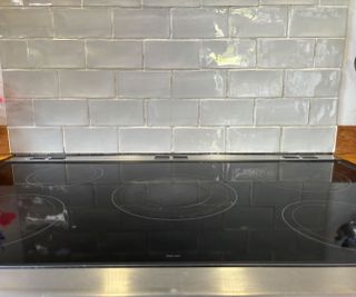 ceramic stove with grey metro tiles