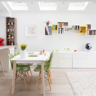 dinning area with white wall cream colour floor and dinning table and chairs