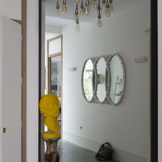 living room with round mirrors on white wall