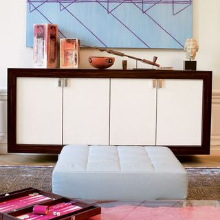 sideboard with cabinet and white wall